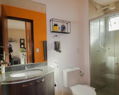 a bathroom with a toilet and a sink and a shower at Paraíso de Maracajaú 4 in Maxaranguape