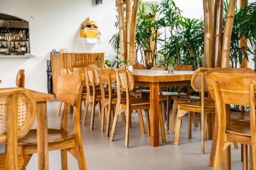 a dining room with wooden tables and chairs at Shanti Boutique Retreat in Tanah Lot