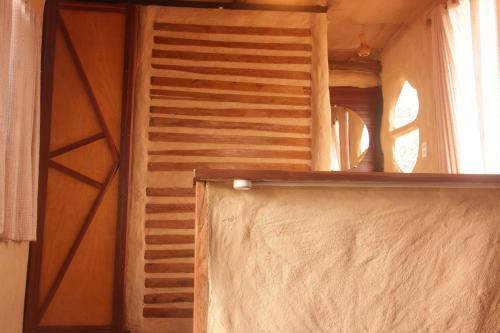 a room with a wooden wall and a window at BioChalé Buena Vista in Sao Jorge