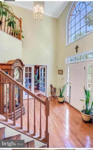 a large living room with a staircase and a large window at PEACE HOME(EVENTS ALLOWED) in Hughesville