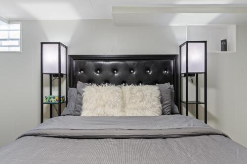 a bedroom with a bed with a black headboard at Luxury chicago suite in Chicago
