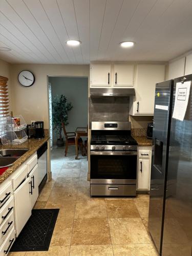 a kitchen with a stainless steel stove and refrigerator at Private Room with Private Bath in Rialto