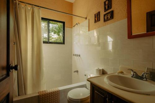 a bathroom with a sink and a shower and a toilet at Villa Ka: Relax with fresh air and mountain view. in Jarabacoa