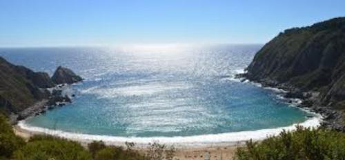 a view of a beach with the ocean at Hostal Terukita in Valparaíso