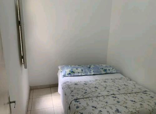 a small bedroom with a bed in a room at Apto Leme RJ- Lindo 2 quartos. A uma quadra da praia. in Rio de Janeiro