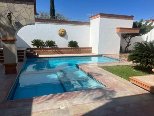 a swimming pool in front of a house at Cara relax & nature in Tequisquiapan