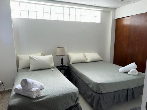 a bedroom with two beds with towels on them at 176 Calle Perez 2A1 in San Juan