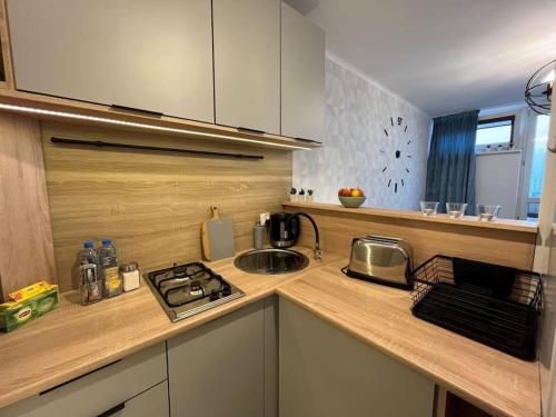 a kitchen with a sink and a counter top at Apartament z panoramicznym widokiem w Centrum in Warsaw