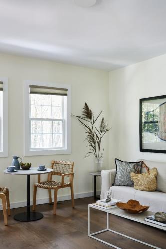 a living room with a white couch and a table at The Roundtree, Amagansett in Amagansett