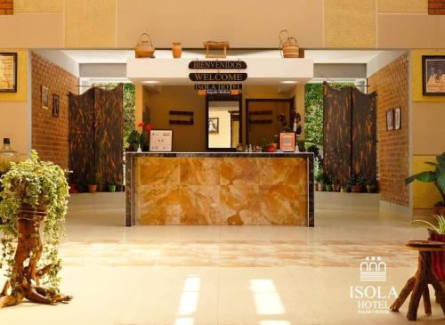 a lobby with a large counter in a building at Hotel Isola by Aiquile in Aiquile