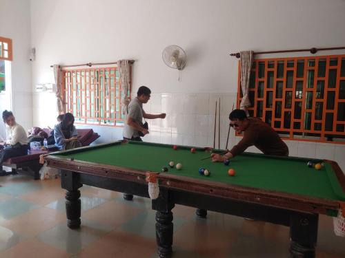 a group of people playing a game of pool at Centro Guest House in Siem Reap