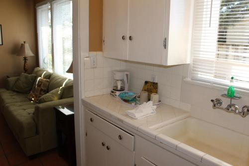 a kitchen with a sink and a couch at The Conch House Marina Resort in St. Augustine