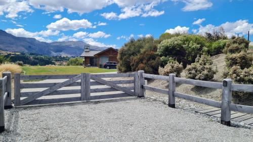 a wooden fence in front of a house at Tucker Beach Private Exclusive Retreat in Queenstown