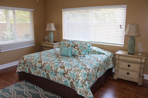a bedroom with a bed, a dresser, and a window at The Conch House Marina Resort in Saint Augustine