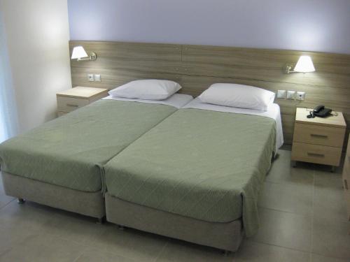 A bed or beds in a room at Alexandros