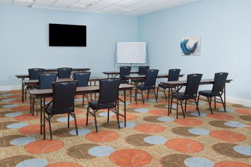 a room with tables and chairs on a carpet at Staybridge Suites Las Vegas - Stadium District in Las Vegas
