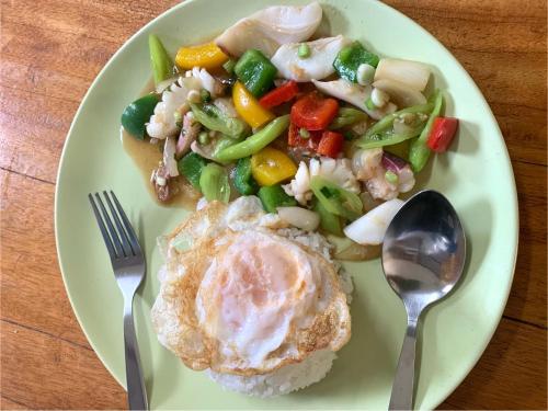 a plate of food with an egg and vegetables at kohkoodfarmstay in Ban Ao Yai