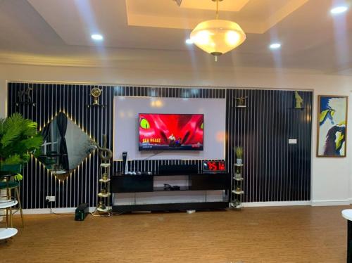 a room with a flat screen tv on a wall at WATER VIEW 3 BEDROOM APARTMENT WITH JACUZZI PARKING WiFi NETFLIX POOL in Lekki