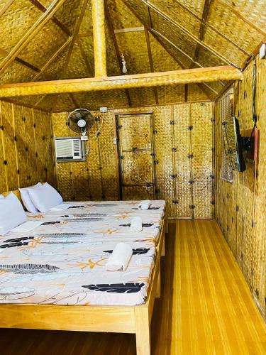 a bedroom with a bed in a wooden room at Casa Gracia's Hotel and Restaurant in San Aquilino