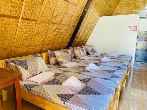 a large bed with pillows on it in a room at Casa Gracia's Hotel and Restaurant in San Aquilino
