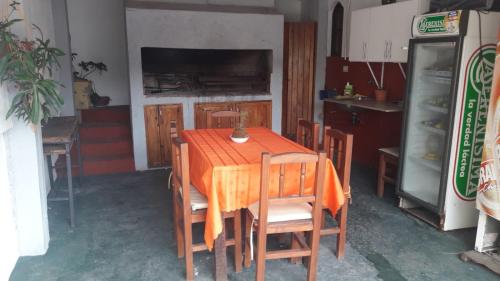 a kitchen with a wooden table with chairs and a refrigerator at Alquileres y más in Villa Carlos Paz