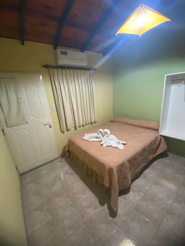 a bedroom with a bed with a towel on it at Alquileres y más in Villa Carlos Paz