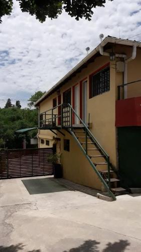 a building with a staircase on the side of it at Alquileres y más in Villa Carlos Paz