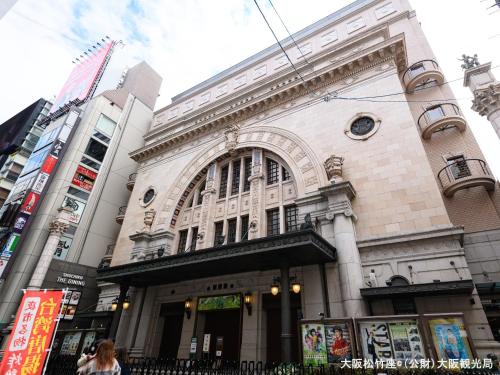a building in the middle of a city at APA Hotel Namba Shinsaibashi Higashi in Osaka