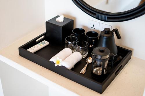 a black tray with napkins and glasses on a counter at Shanti Boutique Retreat in Tanah Lot