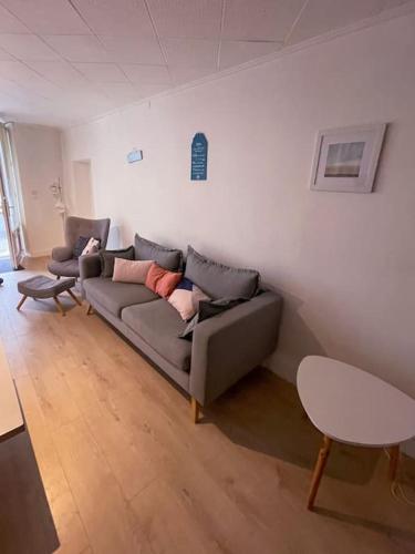 a living room with a couch and a table at Gite Des Lacs Jumeaux in Clairvaux-les-Lacs