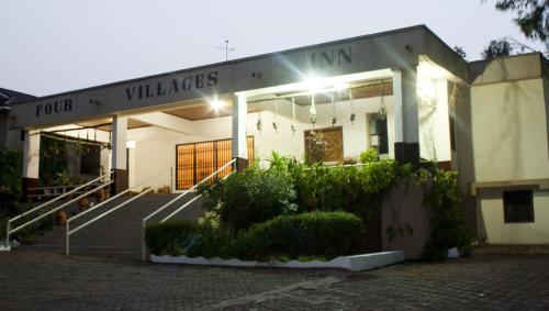 a building with lights on the front of it at Four Villages Inn in Kumasi