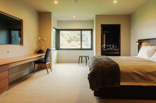 a hotel room with a bed and a desk and a desk at Faraway on Flinders Island 