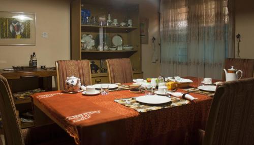 a dining room table with a table cloth on it at Four Villages Inn in Kumasi
