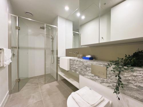 a bathroom with a shower and a toilet and a sink at 1 BRM 1 Study 1 BATH, Southern Cross Station, Flagstaff Garden in Melbourne