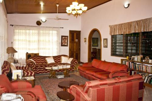 a living room with couches and chairs and a table at Four Villages Inn in Kumasi