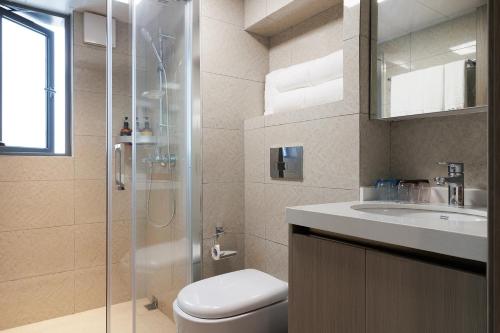 a bathroom with a shower and a toilet and a sink at East Maple Hotel Apartment - Guangzhou Financial City Sanxi Metro Station in Guangzhou