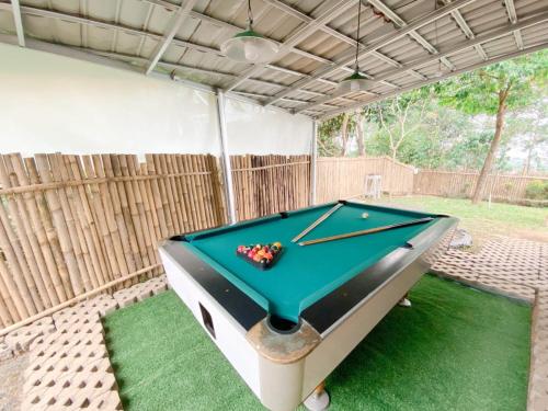 a pool table sitting inside of a garage at Villa Bamboe in Puncak