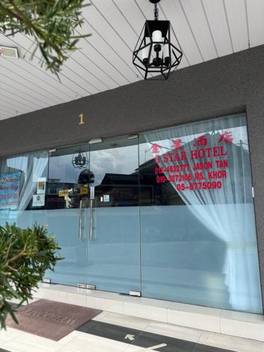 a building with a sign on the front of it at G Star Hotel in Pantai Remis