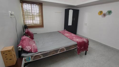 a small bedroom with a bed in a room at Sri Krishna Cottage in Yelagiri