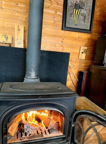 a stove with a fire inside of it at Homey Inn Enya in Yufuin