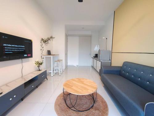 a living room with a blue couch and a table at Skytree A0802-(1) Netflix Aeon ByStay in Johor Bahru
