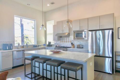 a kitchen with a large island with bar stools at Comfortable Modern Home in Downtown Houston - Sleeps 10 in Houston