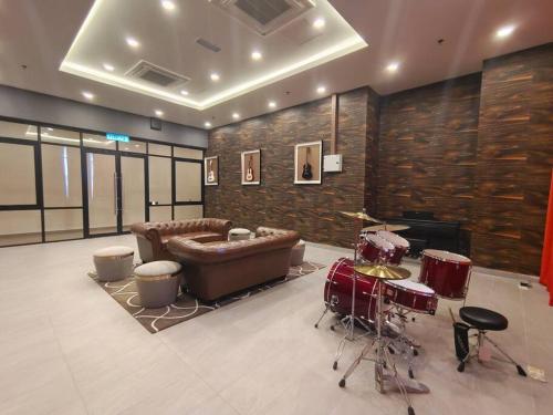 a living room with a couch and drums in it at Skytree A0802-(2) Nobles Room / Aeon in Johor Bahru