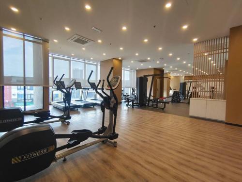 a gym with cardio equipment in a large room with windows at Skytree A0802-(2) Nobles Room / Aeon in Johor Bahru
