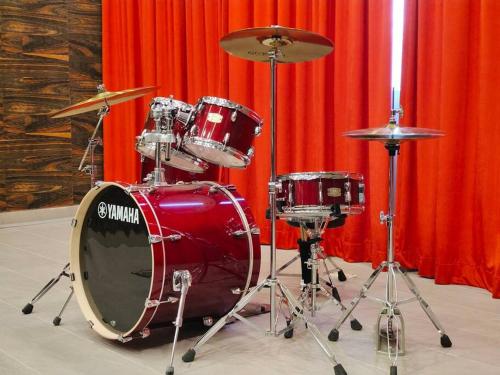 a red drum set sitting next to a red curtain at Skytree A0802-(2) Nobles Room / Aeon in Johor Bahru