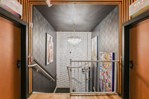 a hallway with a walk in shower with a staircase at Verdant Statuesque Intimate Acropolis Views Of Famous Park in Atlanta