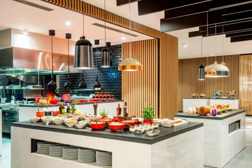 a large kitchen with a buffet of food at Sheraton Grand Tbilisi Metechi Palace in Tbilisi City