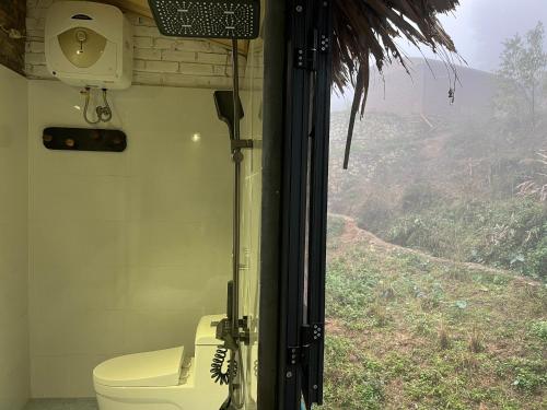 a bathroom with a toilet and a view of a mountain at La Maison SAPA - Bungalows in Sa Pa