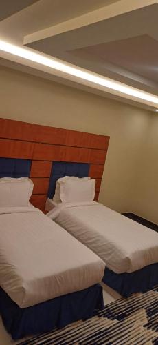 two beds sitting next to each other in a bedroom at ريف الخرج 2 للشقق الفندقية in Al Kharj