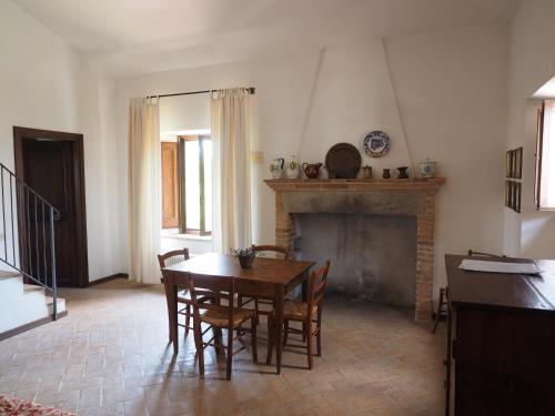 a dining room with a table and a fireplace at Agriturismo Piano Grande in Avigliano